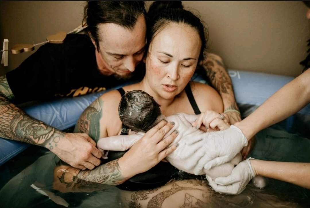 Mother and Father and Baby Water Birth