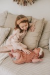 Acorn Birth Center Young girl caring for baby on couch